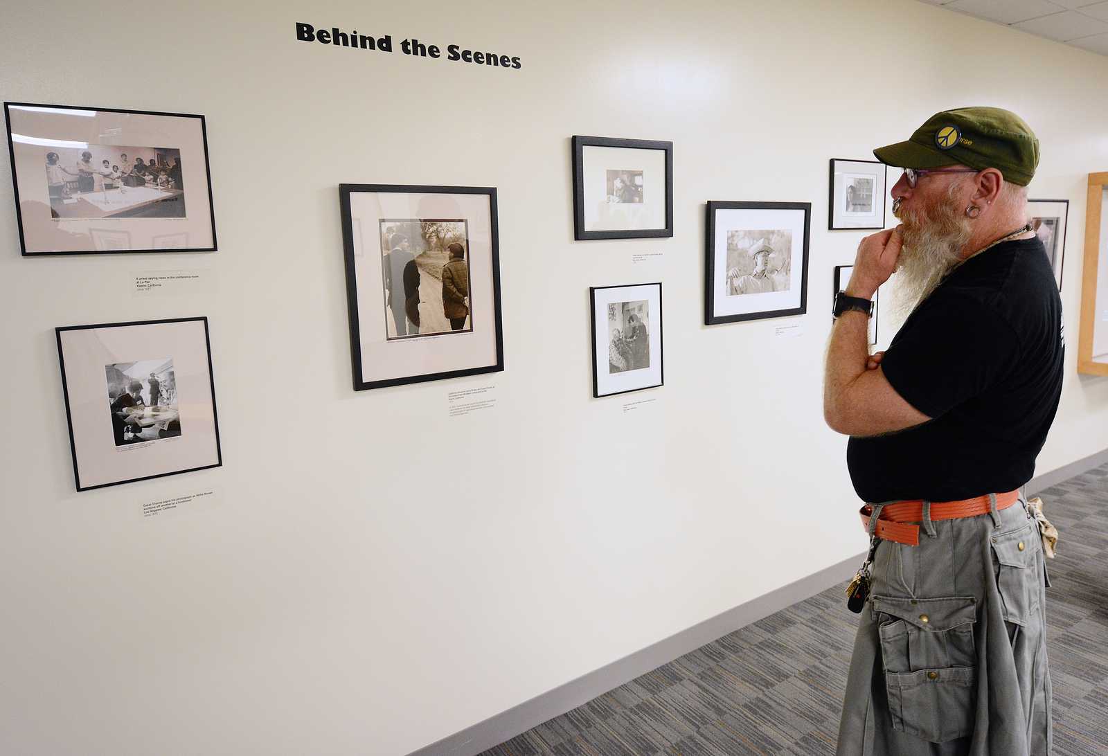 Woody Miller, graduate student, observes photographs in the Marching Through History with Cesar Chavez and the Farm Workers exhibit at J. Paul Leonard Library on Monday, Sept. 16, 2013. Photo By Philip Houston / Xpress