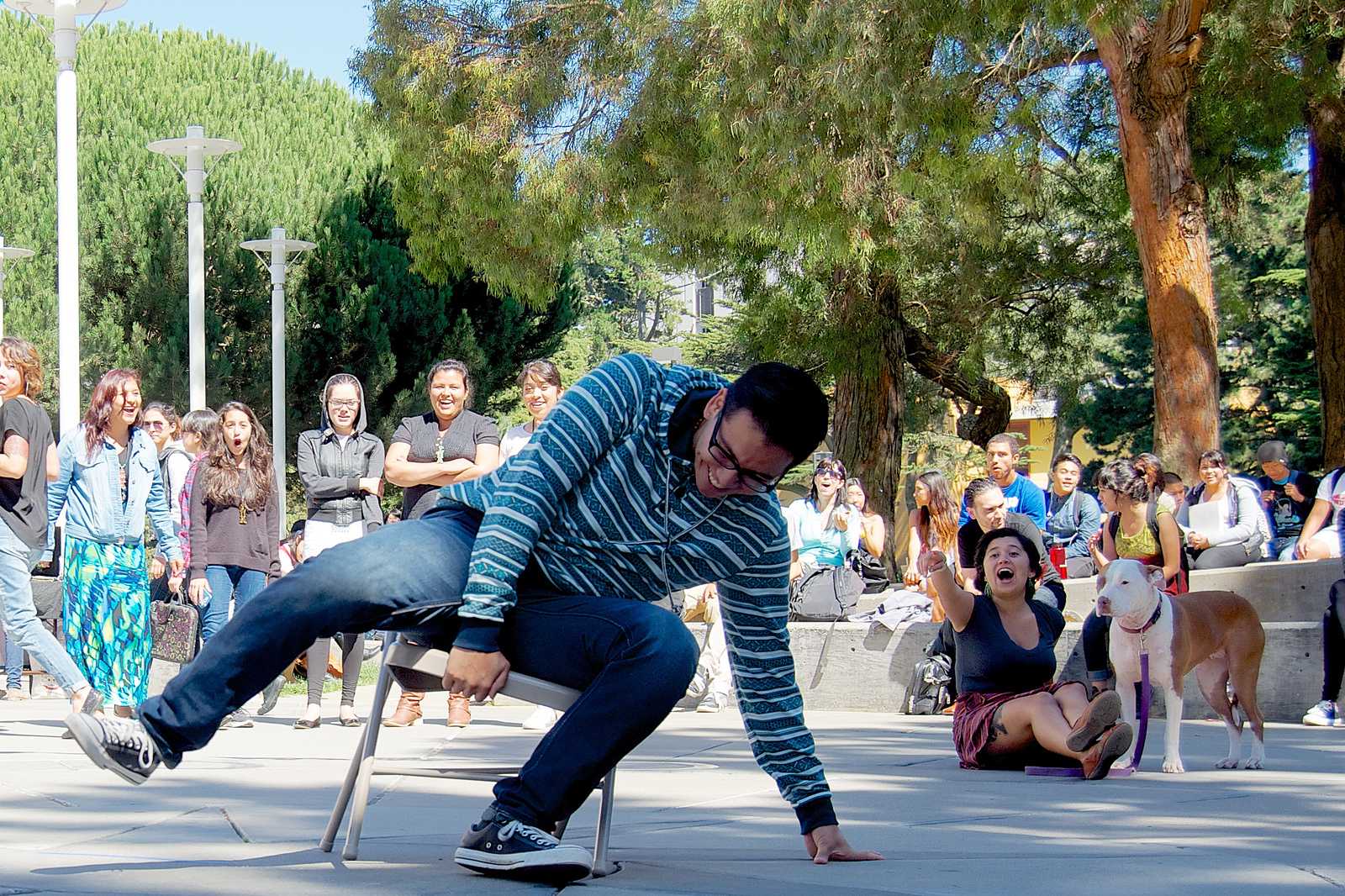 Javier Morelos Garza grabs the final seat during musical chairs at the La Raza Student Organization's festival in Malcolm X Plaza Sept 18, 2013. Photo by Kate O'Neal / Xpress 