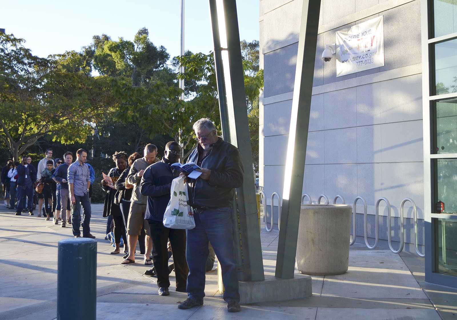 People stand in line at the Claremont DMV waiting for the doors to open at 8 a.m. Monday, Sept. 23, 2013 in Oakland, Calif. Photo by Amanda Peterson / Xpress 