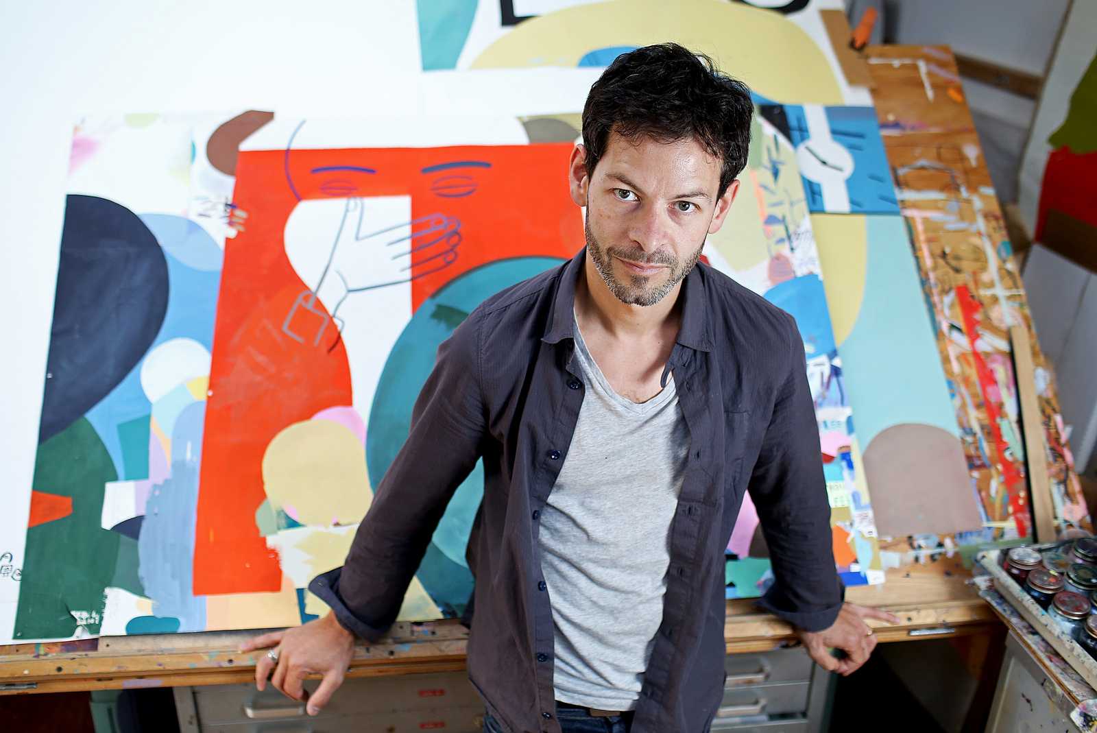 Jason Jägel, a San Francisco based local artist who is featured in the Illuminated Library Exhibit at SF State, stands in his studio located in the Mission District. Photo by Virginia Tieman / Xpress