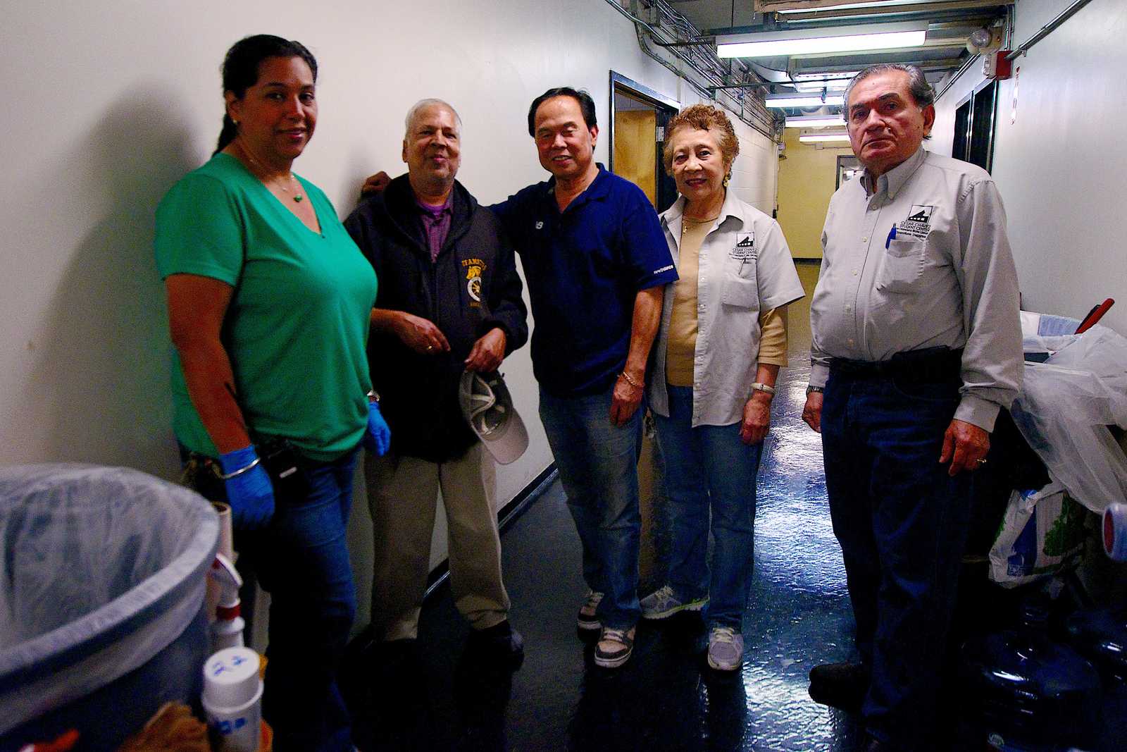 Erika Santos, Naresh Mathur, Bernie Carrera, Maria Suarez and Carlos Rosales pose for a photo in the basement of Cesar Chavez Wednesday Oct 30, 2013. The unionized custodial staff of Cesar Chavez Student Center are unsure where their union will stand following a campus auxiliary merger. Photo by Kate O'Neal / Xpress
