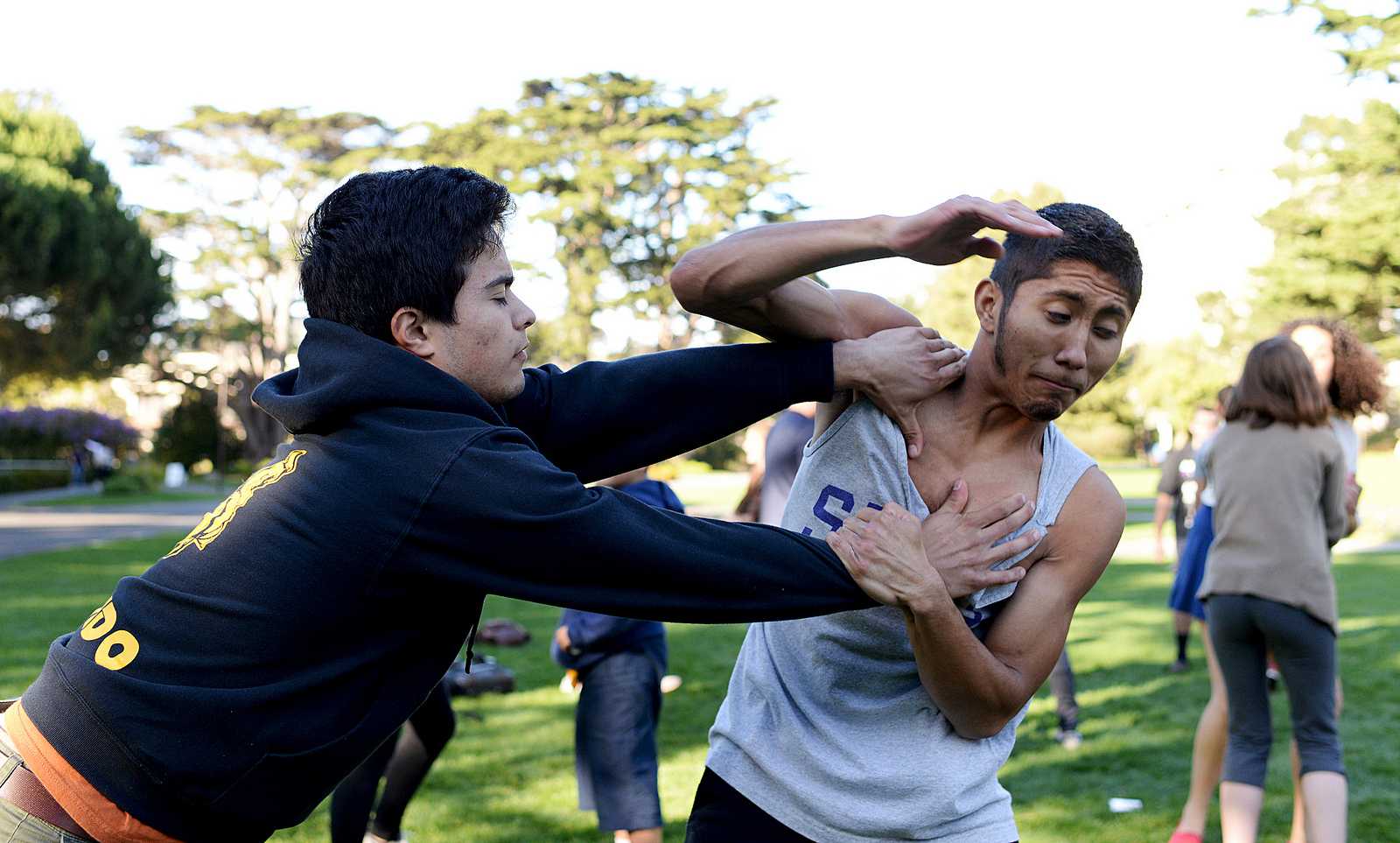Oscar Hernandez (left) practices Krav Maga moves with Micky Mejia (right) during a Women's Center sponsered event where self defense was taught to participants in the Quad at SF State on Thursday, Nov. 7, 2013. Photo by Virginia Tieman / Xpress