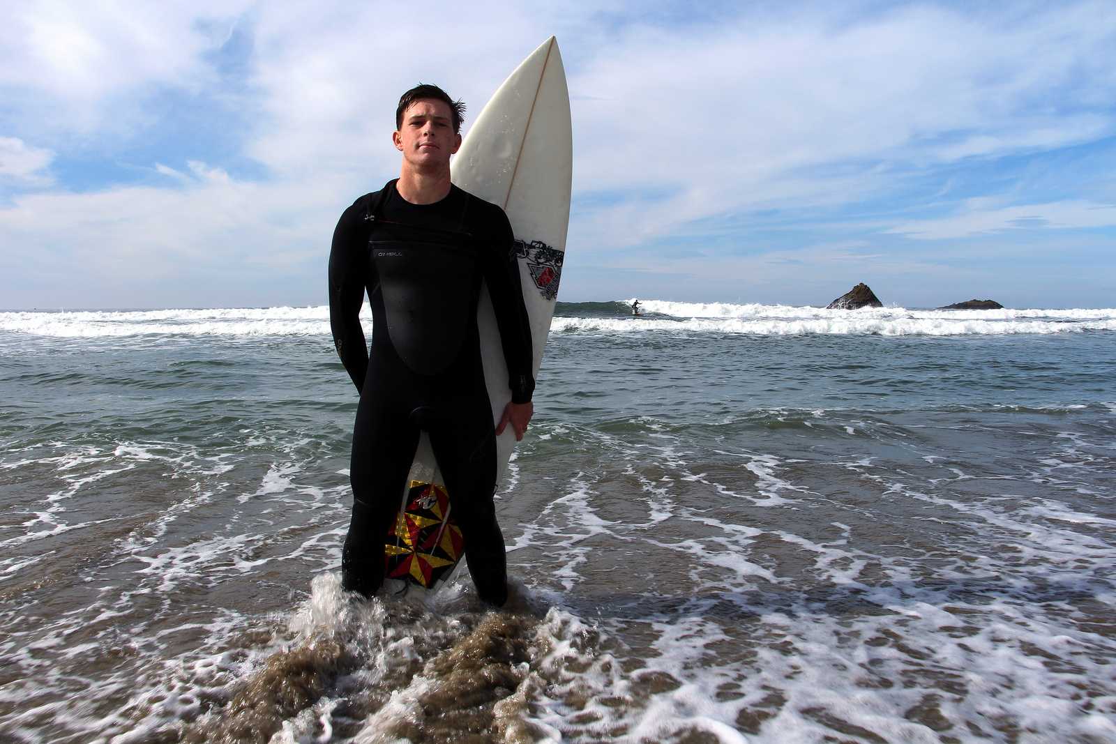 Colin Dwyer, a Psychology major at SF State, stands on the shore of Pacifica State Beach, Monday, Nov. 11, 2013. Dwyer is a professional surfer who will be competing in the Mavericks Invitational, a big wave surf contest in Half Moon Bay, so he trains by surfing at a local beach. Photo by Gavin McIntyre / Xpress