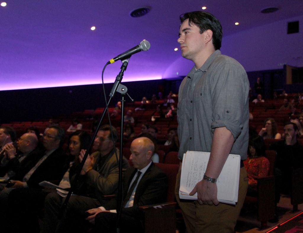 Michael Buelna, a Zoology major, asks a question to the speakers at the town hall meeting on the science building closure, in SF State's McKenna Theatre, Feb. 13, 2014. Buelna has had a few classes in the science building. Photo by Gavin McIntyre / Xpress