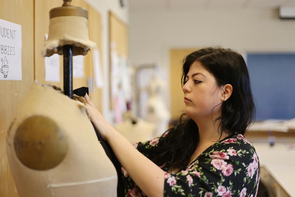 Monica Arana, senior, drapes cloth on a mannequin for one of her designs Tuesday, March 18, 2014. The clothes will be modeled at the Provoke Spring Fashion Show May 1. Photo by Ryan Leibrich / Xpress