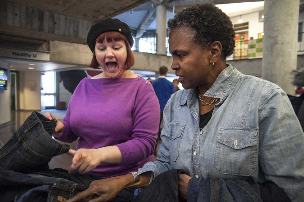 Heather Shetrawski (left) reacts to discounted jean prices while Leslie Bilbro, a Goodwill volunteer, assists her during Levis Mendables Earth Day event sponsored by Goodwill in Cesar Chavez Student Center at SF State Tuesday, April 22. Photo by Jessica Christian / Xpress