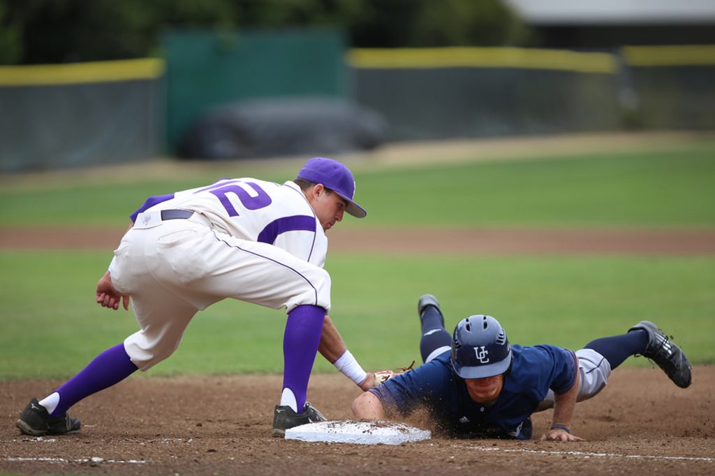 SF States Garret Heisinger attempts to strike out UC San Diegos Erik Lewis during the first game of a doubleheader against SF State at SF State Maloney Field Friday, April 18. Photo by Rachel Aston / Xpress