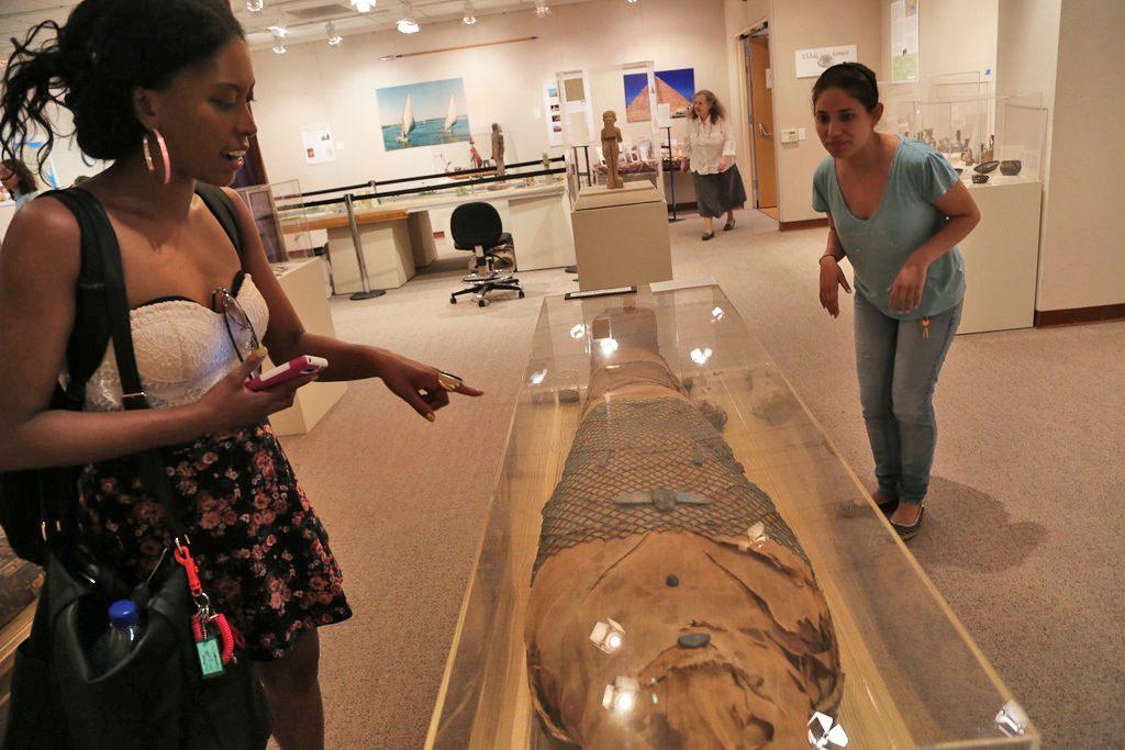 Rowena Luis, an Africana studies junior, looks at a mummy at the Egypt Calls You! exhibit in Humanities 510 Wednesday, April 30. Photo by Rachel Aston / Xpress