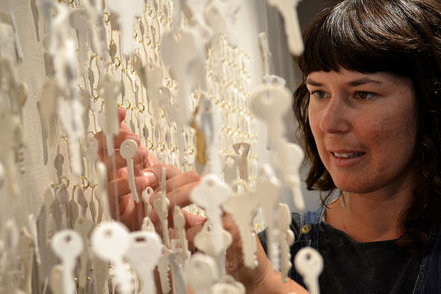 Despite a meticulous transport, SF State alumna Shenny Cruces untangles knots in her "Keys" installation during a reception in the Alumni Hall Art Gallery Friday, Sept. 19. The exhibit will remain on display  in the Administration Building until January 5, 2015. Annastashia Goolsby / Xpress.