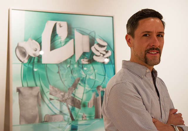 Assosciate Professor Matthew Lipps poses for a portrait with one of his works, a C-print (Chromogenic Print) entitled "Art" (2013), in the Fine Arts Gallery at SFSU on Tuesday, Sept. 9, 2014. Eric Gorman / Xpress