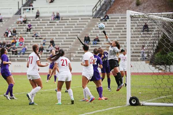 Cal State East Bay Pioneer goal keeper Briana Scholtens, #1, punches the ball out of danger after a SF State Gator attempt on goal at Cox Stadium on Sunday, Sept. 28, 2014. Sara Gobets / Xpress.