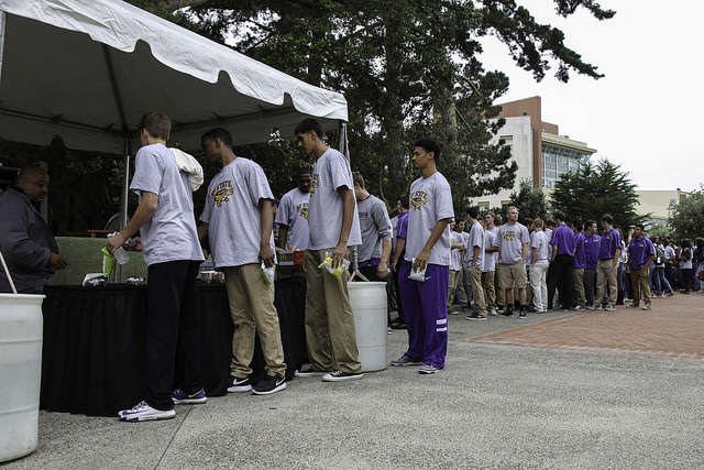 Sporting new t-shirts, SF State athletes line up for free food in Don Nasser Family Plaza just before the reopening ceremony of the newly remodeled gymnasium on Thursday, Sept. 11, 2014. Frank Ladra / Xpress.