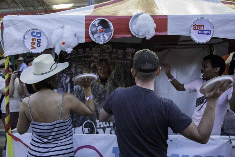 Fair attendees throw cream pies at the face of a participant during the Castro Street Fair in San Francisco Sunday, Oct. 5, 2014. Frank Ladra / Xpress.