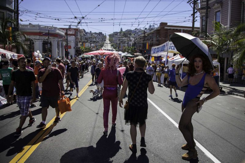 A costumed fair attendee poses for a picture as people walk up and down the street at the Castro Street Fair in San Francisco Sunday, Oct. 5, 2014. Frank Ladra / Xpress.
