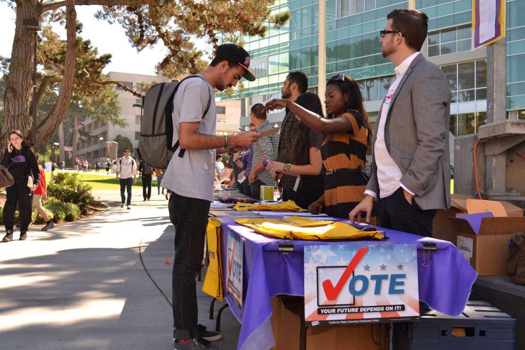 History major Joseph Scimonelli registers to vote at the campus government and community relations table Monday, Oct. 13, 2014. The event was intended to encourage students who have not yet registered to participate in the November election.