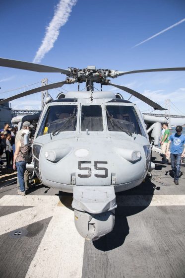 Blake Randall (right) walks around a military helicopter during a tour aboard the USS America Monday, October 13, 2014. Martin Bustamante / Xpress.