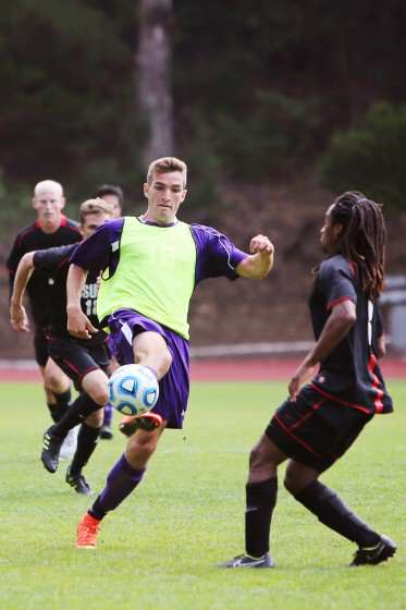SF State Gator forward Cameron DeJong, # 16, volleys the ball out of the air away from advancing Cal State East Bay players, Kellen Crow, #15, and Arthur Ethel, #3, at Cox Stadium on Sunday, Sept. 28, 2014. Sara Gobets / Xpress.