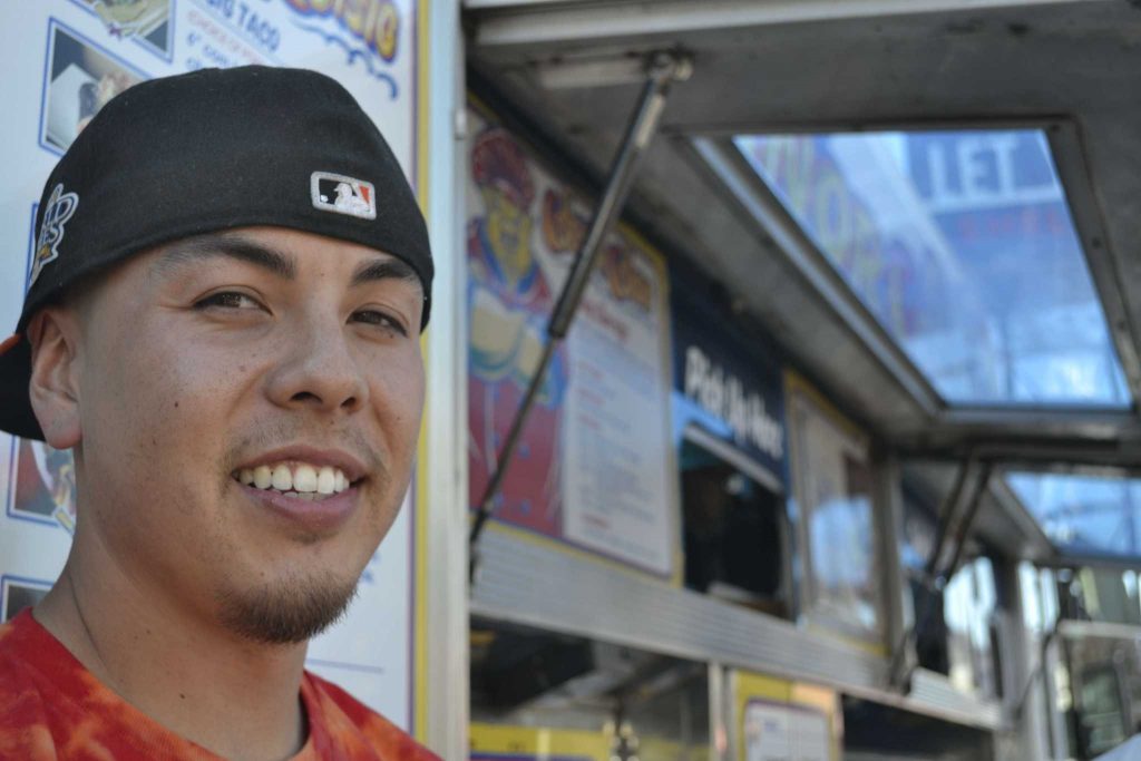 Sf State alumnus and co-founder of Señor SiSig Evan Kidera takes a break from his busy day to pose for a photo in front of his truck at the Soma Street Food Park Friday afternoon, Oct. 3, 2014.