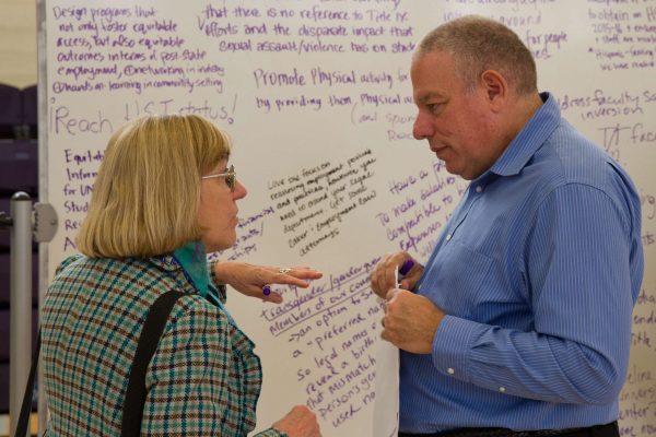 Deborah C. Masters, University Librarian, and John Elia, Associate Dean of Health and Social Sciences, discuss the topics expressed at the Equity table during the Academic Senate's Strategic Plan meeting in the SF State Gymnasium Tuesday, Oct. 21, 2014. Eric Gorman/Xpress.