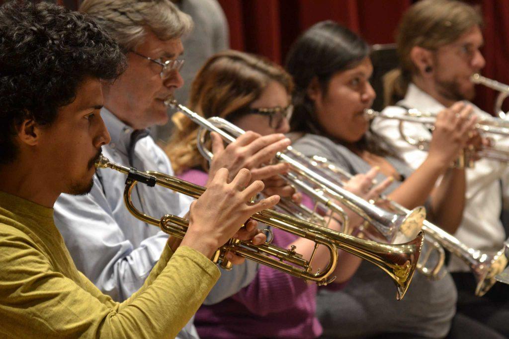 The trumpet section plays during a rehearsal with the SF State Wind Ensemble in preparation for A Honeymoon in Paris Thursday, Oct. 9, 2014.
