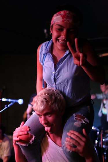 SF State freshman, Ruby Felix, posed for a picture on the shoulder's of Hot Flash Heat Wave's Adam Abildgaard, after their set Thursday, Oct. 16, 2014.. Lorisa Salvatin / Xpress.