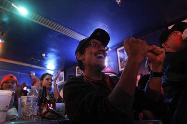 Juan Santamaria, a senior Latin studies major, cheers for the Giants during the bottom of the ninth inning during Game 1 of the World Series with the SF Giants against the Kansas City Royals at the Pub at SF State Tuesday, Oct. 21, 2014. Daniel Porter / Xpress.