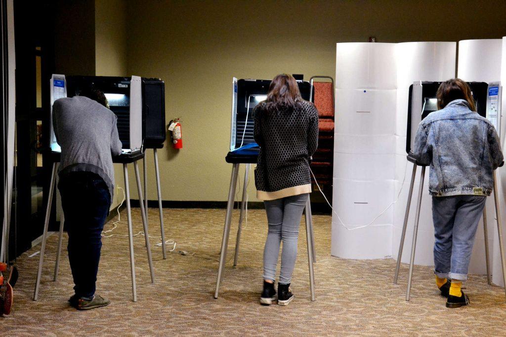 (Left to right) First time voters Ryan Doyle, Lindsey Herbert and Xiomara Duran cast their ballots in the Junior Towers at SF State on election night Tuesday, Nov. 4, 2014. Helen Tinna/Xpress.