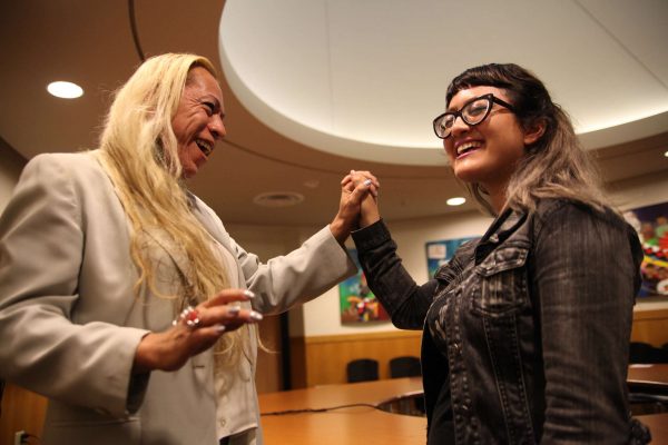 Bamby Salcedo entwines hands with Deziree Miller after Q&A with actvist in the ROMC Reading Room on Thursday, Oct. 30, 2014. Lorisa Salvatin/Xpress.