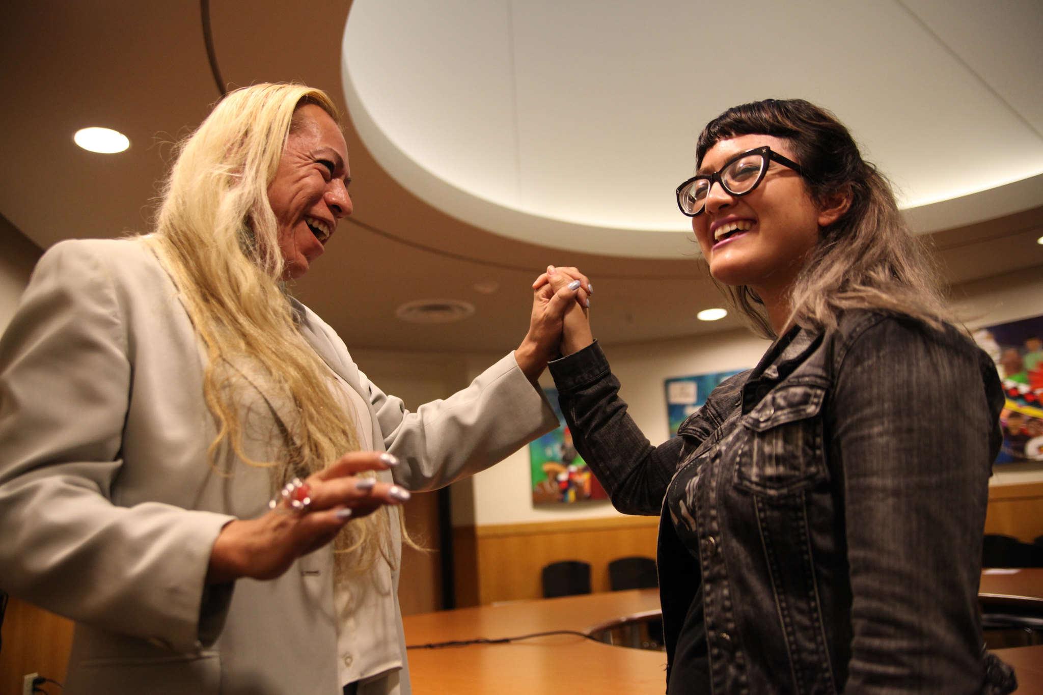 Bamby Salcedo entwines hands with Deziree Miller after Q&A with actvist in the ROMC Reading Room on Thursday, Oct. 30, 2014.