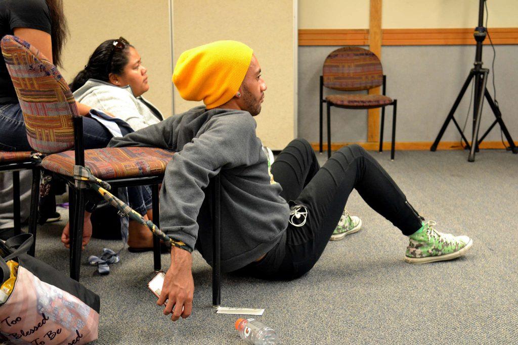 Spulu, a dance major, watches the workshop while still tied to his chair with neckties Wednesday, Oct. 29, 2014.