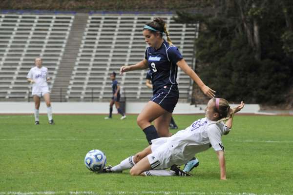 SF State Gators player Autumn Fox, #4, slides to clear the ball away from Sonoma State Seawolves player Cecilia Sifuentes #9, at Cox Stadium Thursday, Oct. 30, 2014. Sara Gobets/Xpress,