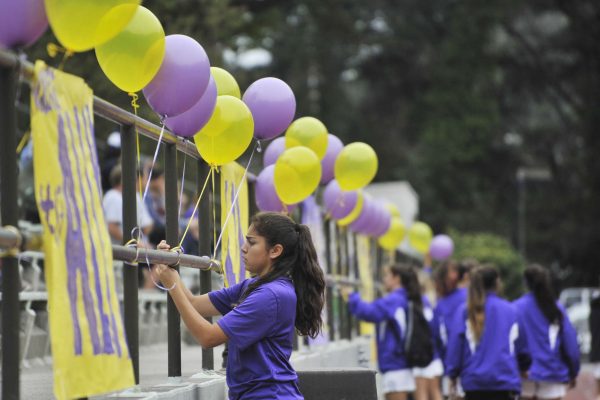 SF State Gators player Karla Uribe and the rest of the women's soccer team decorate the railing at Cox Stadium to honor their graduating players on their last game Thursday, Oct. 30, 2014. Sara Gobets/Xpress.