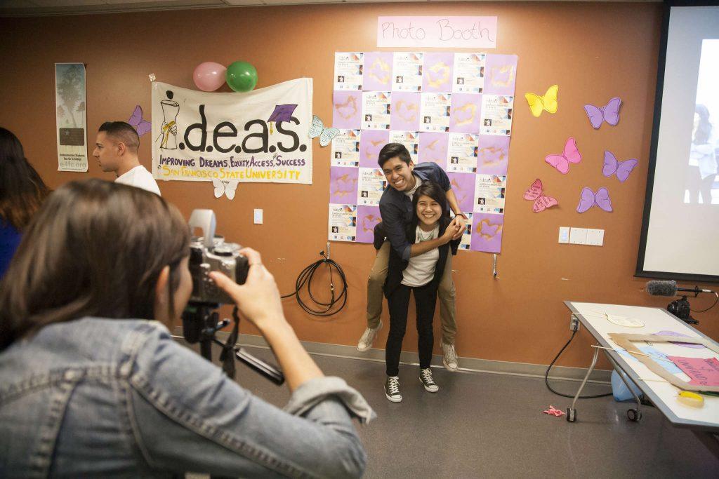 Miguel Castillo and Ana Morales pose for a photo in front of the make shift photobooth at the IDEAS meeting in the library Wednesday, Nov. 12, 2014. Martin Bustamante/Xpress.