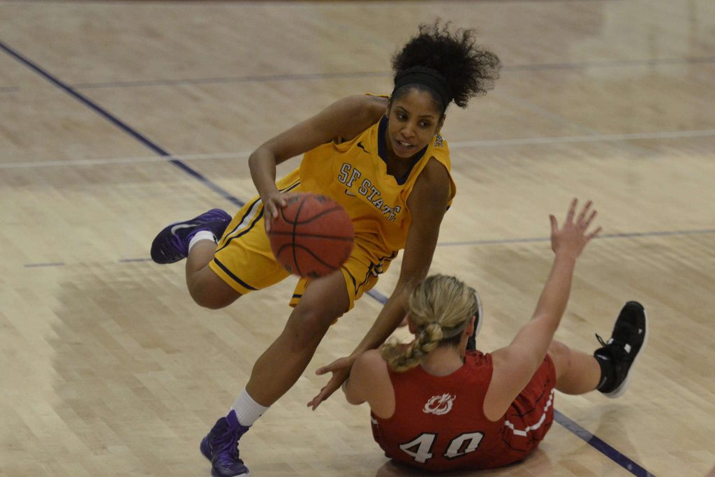 Minnesotas center Savanna Handevidt tries to draw a charging foul from SF State forward Michelle Sutton during a home game Thursday, Nov. 20. SF State Gators lost against the Minnesota Dragons 67-78. Annastashia Goolsby/Xpress.