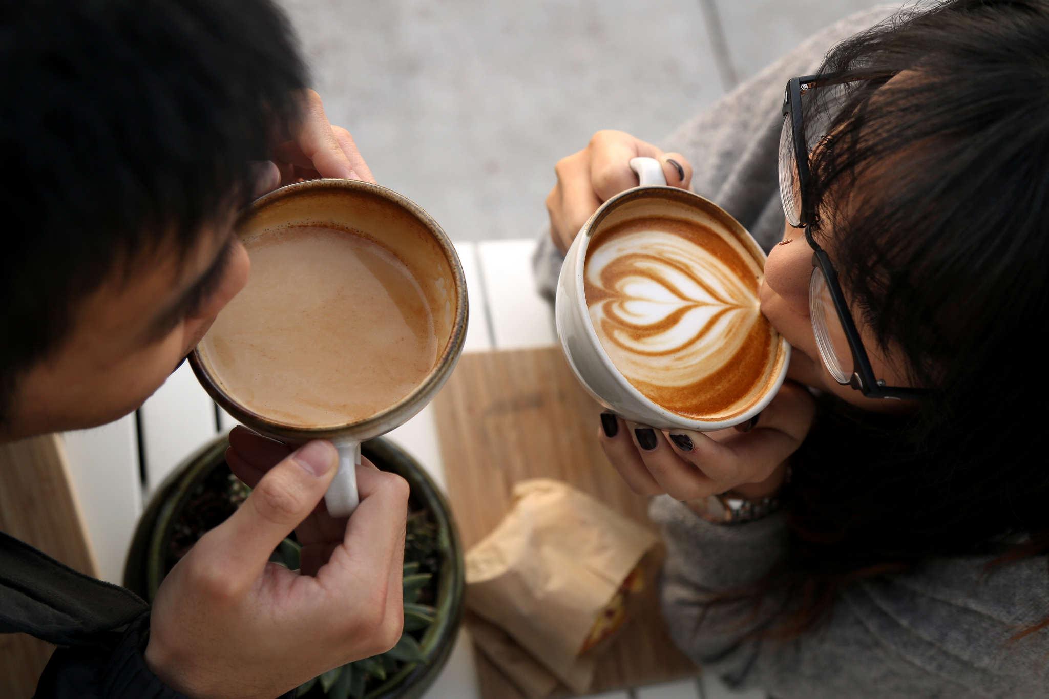 Adrian Chen, BECA major and Tina Huang, international business major drink lattes at Andytown Coffee Roasters in the Outer Sunset of San Francisco on Wednesday Feb 11. One of their favorite ways they enjoy spending time together. (Emma Chiang / Xpress)