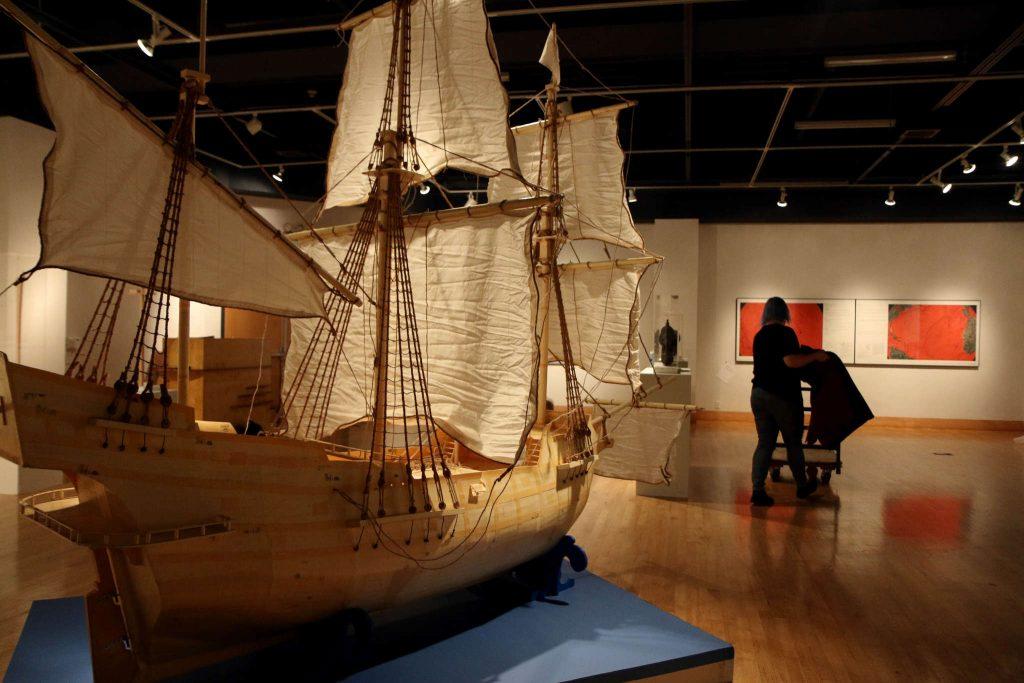 A pirate ship sits in the middle of the room while Emily Vanags, an Art History Major, prepares the Hydrarchy Gallery on Tuesday Feb. 17. (Marlene Sanchez / Xpress)