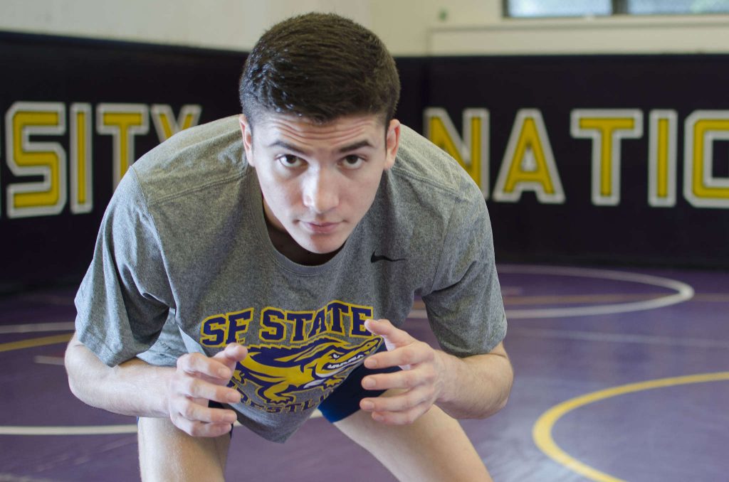 SF+States+leading+wrestler+with+a+record+of+25-9%2C+Jordan+Gurrola%2C+stands+on+the+mats+in+the+gym+on+Monday+Feb%2C+9.