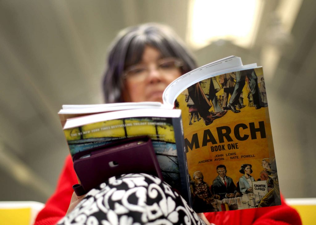 Donna Montero reads March: Book One after her book was signed by the authors Congressman and activist John Lewis and Andrew Aydin in Annex I at SF State on Wednesday February 18, 2015. (Emma Chiang / Xpress)