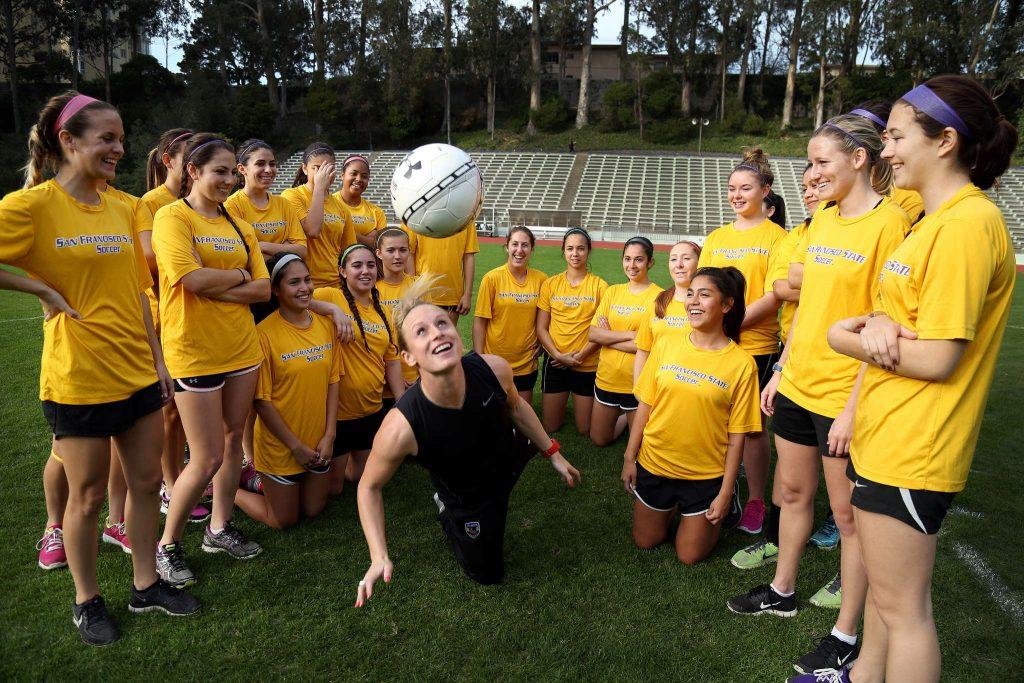 Tracy Hamm, SF States new Head Womens Soccer Coach is the second in the 33-years, succeeding Jack Hyde. Hamm juggles with the ball surrounding the team at Cox Stadium on Monday Feb. 2, 2015. (Emma Chiang/Xpress)
