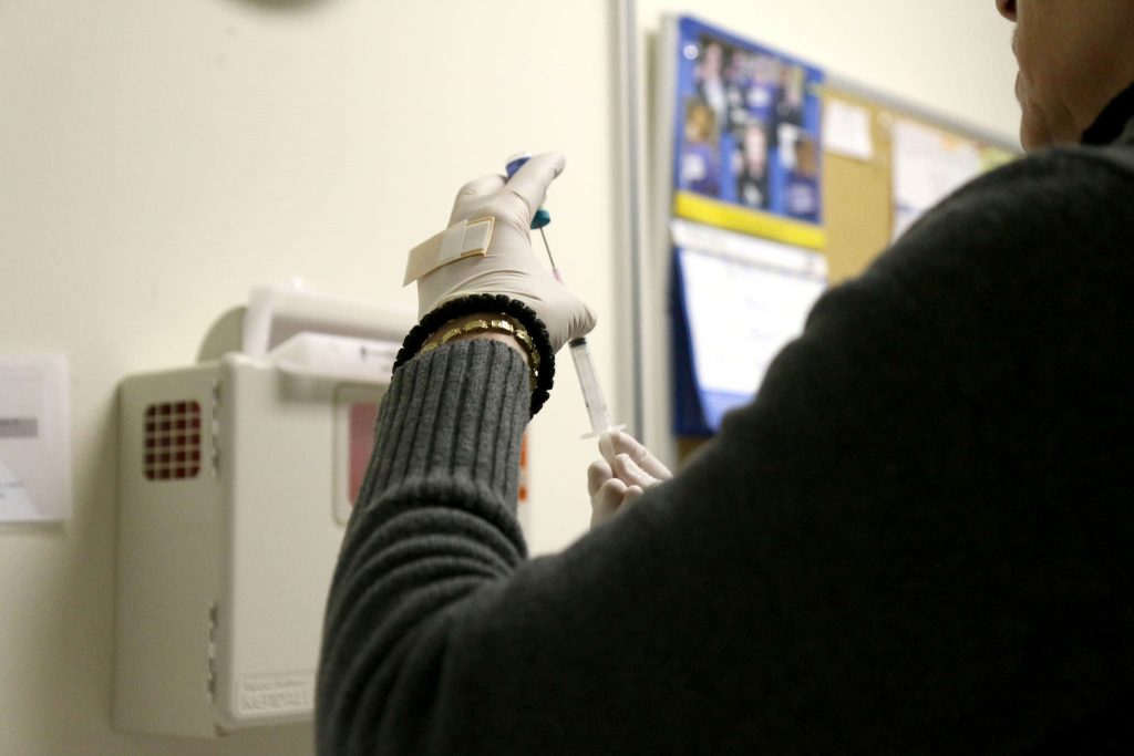 Mira Medan, a Registered Nurse, preps the MMR vaccine at the Student Health Center on Tuesday Feb. 24. The MMR vaccine protects against measles, mumps and rubella. (Marlene Sanchez / Xpress) 