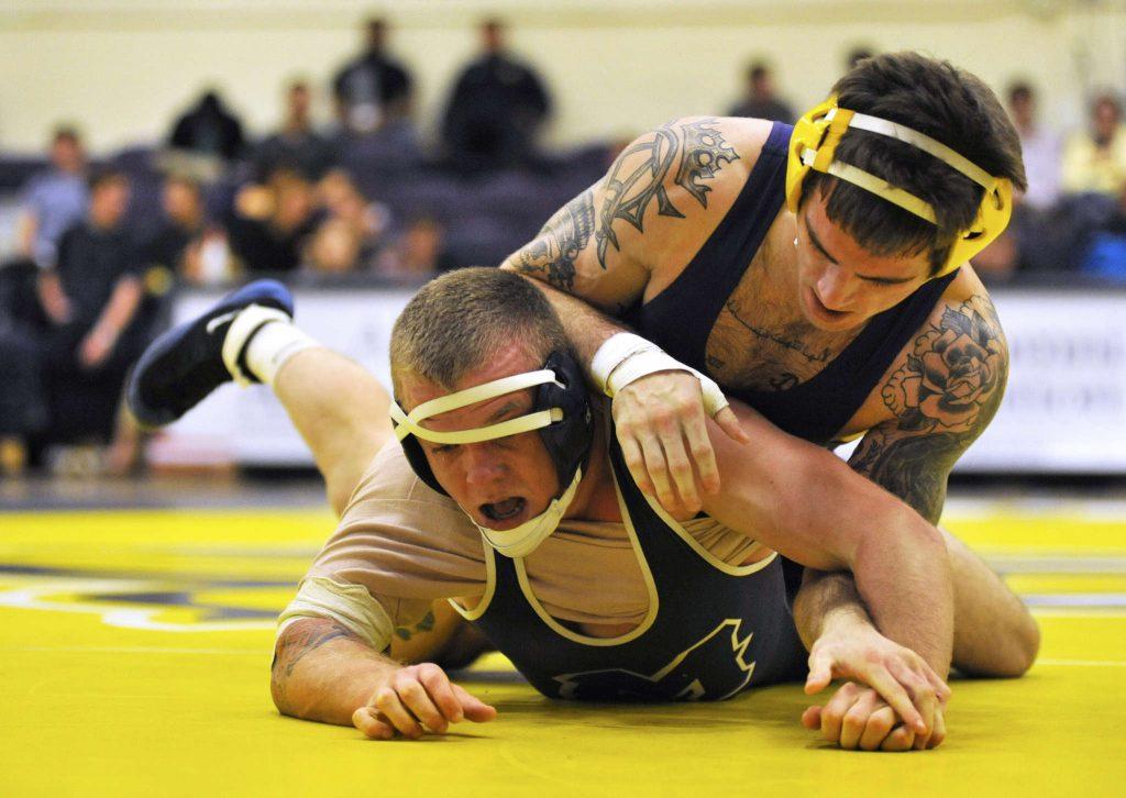 Menlo Oaks player Tyler Thomas wrestles with SF States Alex Abono (and his own headgear) in a match on Thursday, Feb. 12, 2014. 