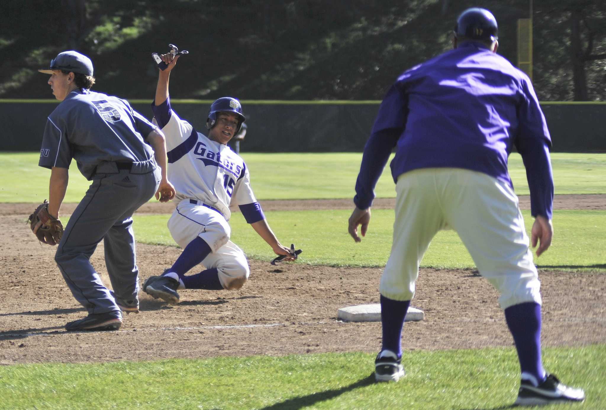 SF State Gators player Joseph Chedid (#15) slides into third base during a game against the Academy of Art Urban Knights on Tuesday, April 14, 2015. (Sara Gobets / Xpress)
