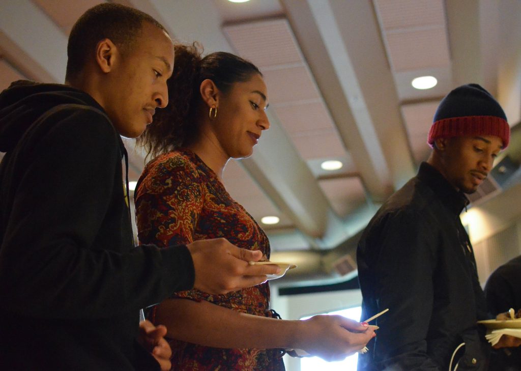 Students get food during the intermission at the screening of Hidden Colors 3: The Rules of Racism at the African American Health Fair in Jack Adams Hall Tuesday, May 5. (Melissa Minton / Xpress
