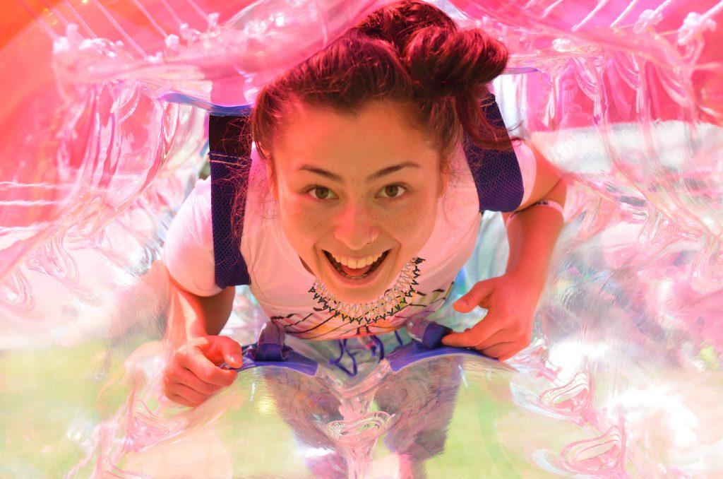 International relations major Nina Bazan-Sakamoto smiles while getting into a bubble for a game of bubble soccer in the Quad Tuesday, May 5. (Melissa Minton / Xpress)