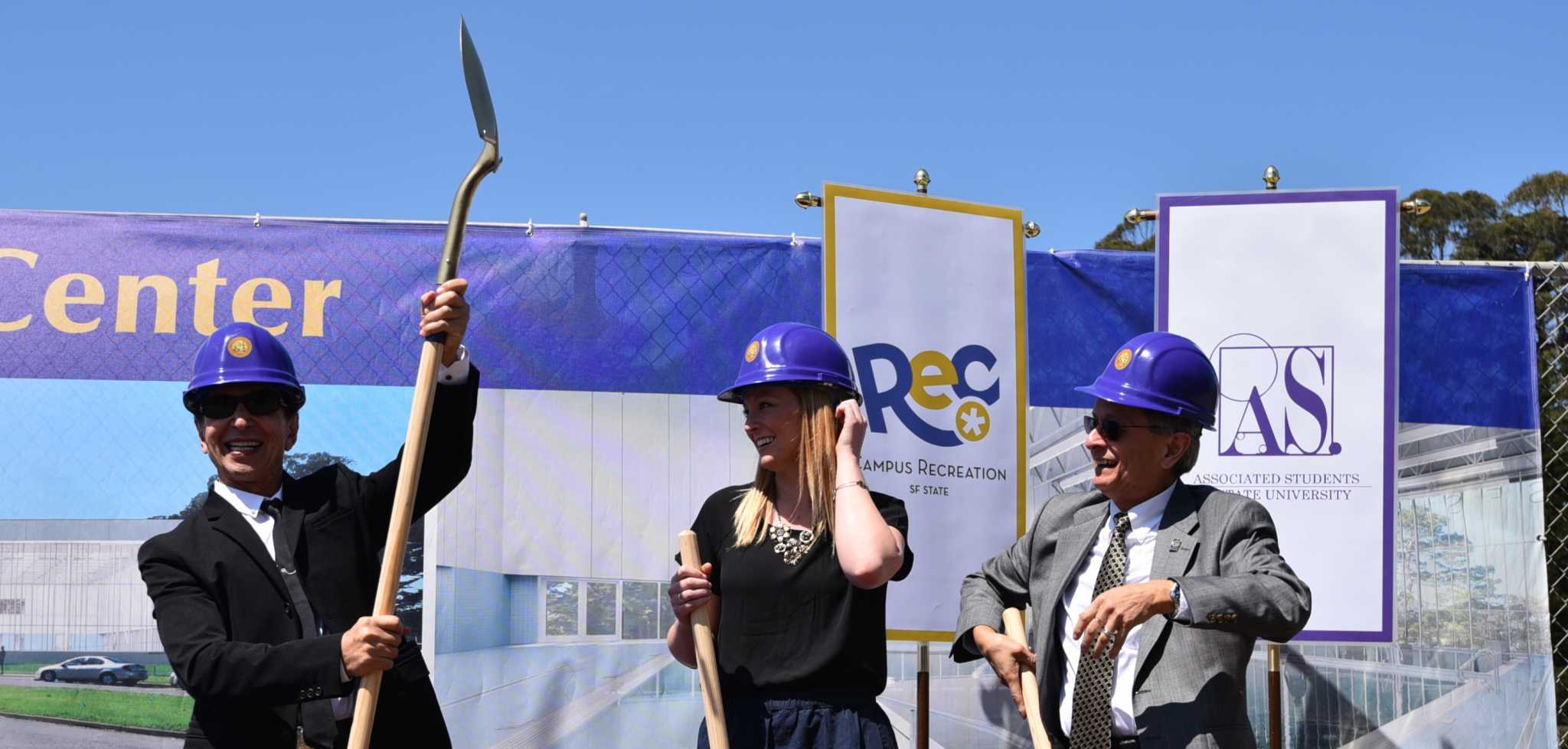(From left) SF State alumnus and Bebe Stores founder Manny Mashouf,  raises his shovel next to Phoebe Dye, president of Associated Students, Inc. and President Leslie E. Wong during the Mashouf Wellness Center groundbreaking ceremony at the SF State softball field Thursday, June 25, 2015. (Xpress / Qing Huang)