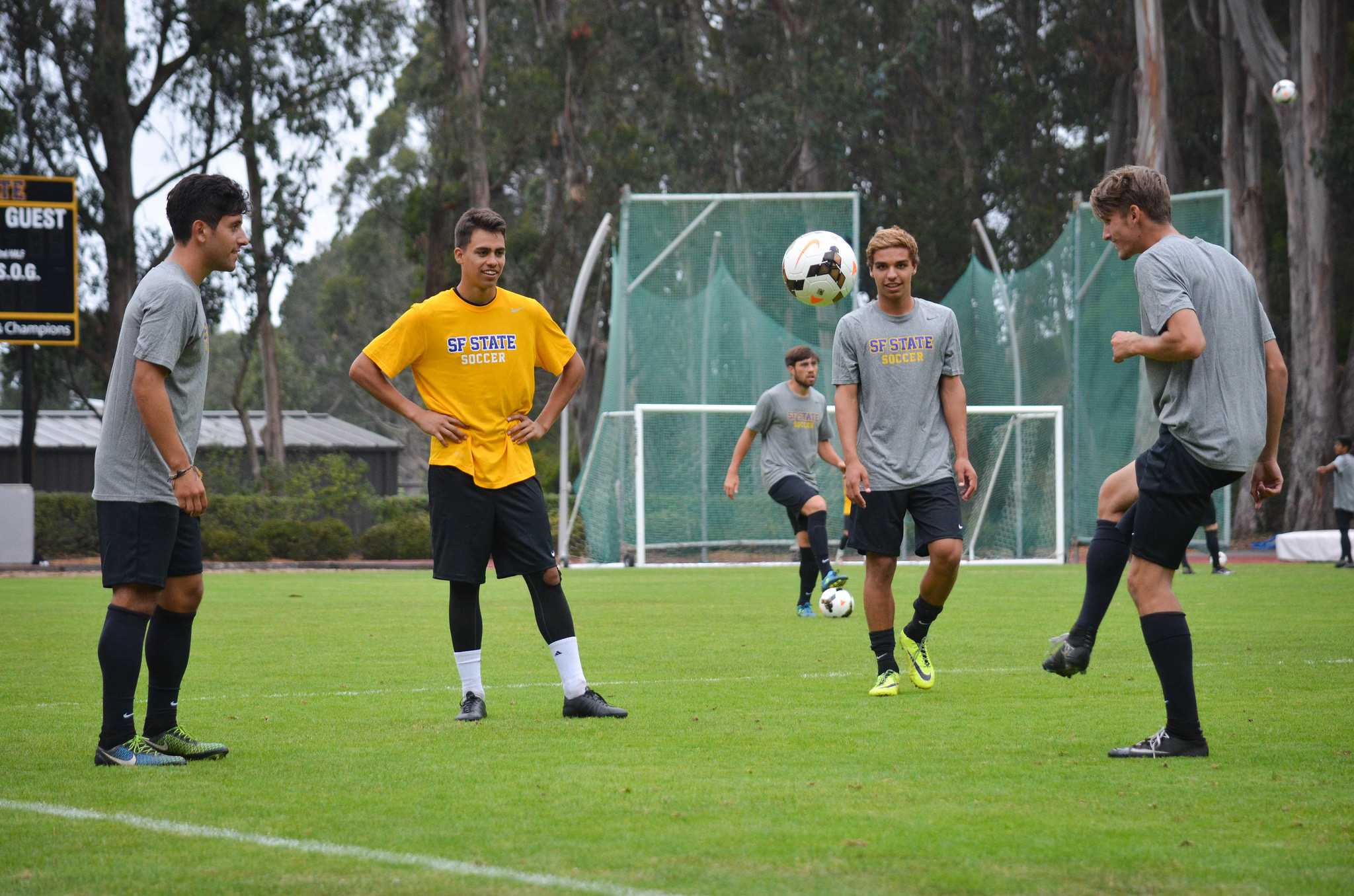 Members of the SF State mens soccer team pass the soccer ball around during practice at Cox Stadium Friday, August 21. (Melissa Minton / Xpress)