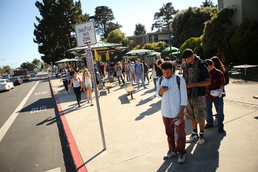 Students wait in line for the SF State shuttle to Daly City BART on 19th Avenue in front of campus Wednesday, Sept. 9, 2015. (Joel Angel Juárez /  Xpress)