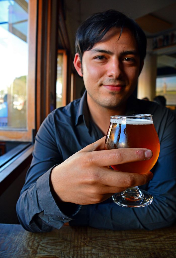 SF State alumni, Sam Molmud, editor-in-chief of Liquid Bread, at the Rosamunde Sausage Grill in San Francisco, Thursday evening, September 10, 2015 (Katie Lewellyn / Xpress).