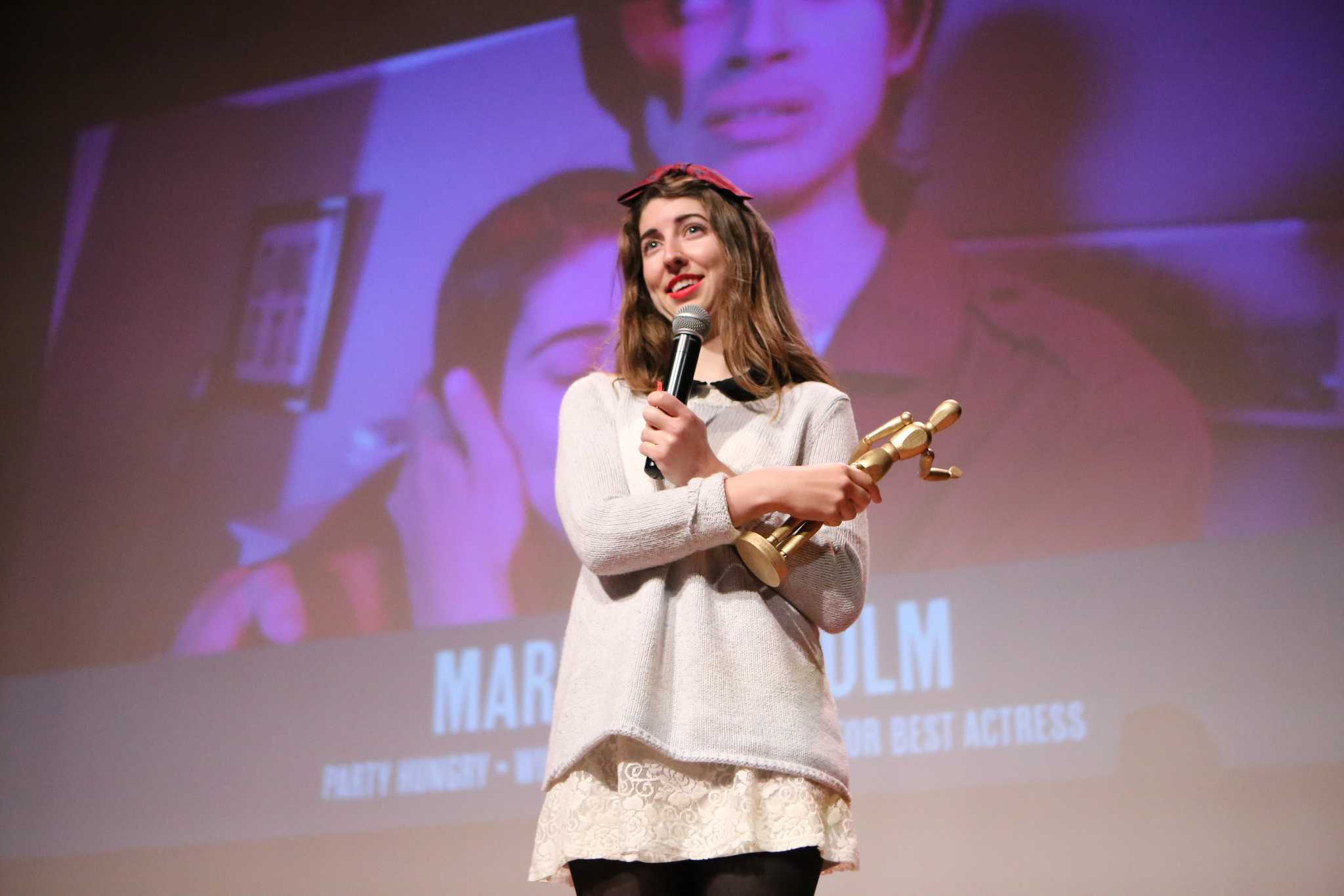 Marian McColm, a senior cinema major, receives the Silver Tripod for Best Actress award for her role in Party Hungry during the Campus MovieFest Finale in Jack Adams Hall at SF State on Thursday October 15, 2015. (Joel Angel Juárez / Xpress)
