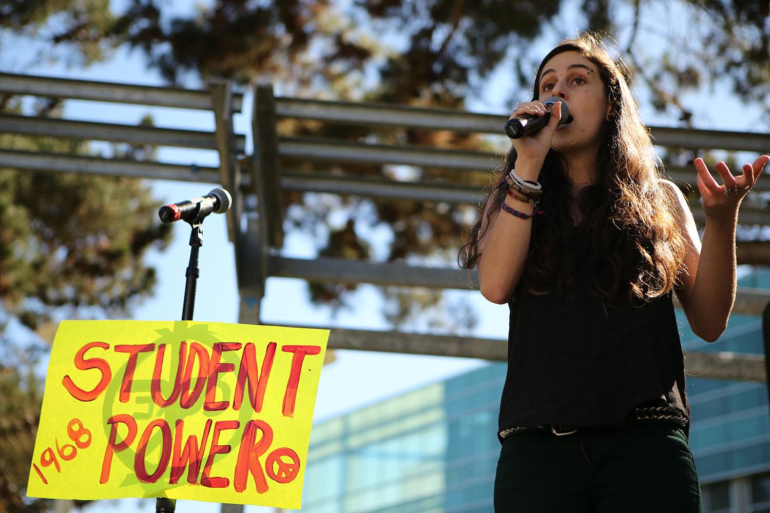 SF State Real Food Challenge member Celia LoBuono Gonzalez, a third year communications and geography major, speaks about pouring rights during the Speak Out rally in Malcom X Plaza on Tuesday, Oct. 20, 2015. ( Joel Angel Juárez / Xpress)